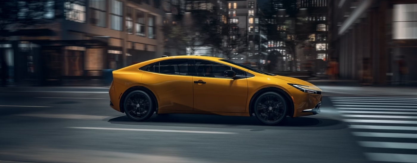Yellow 2026 Toyota Prius Nightshade driving on a city street
