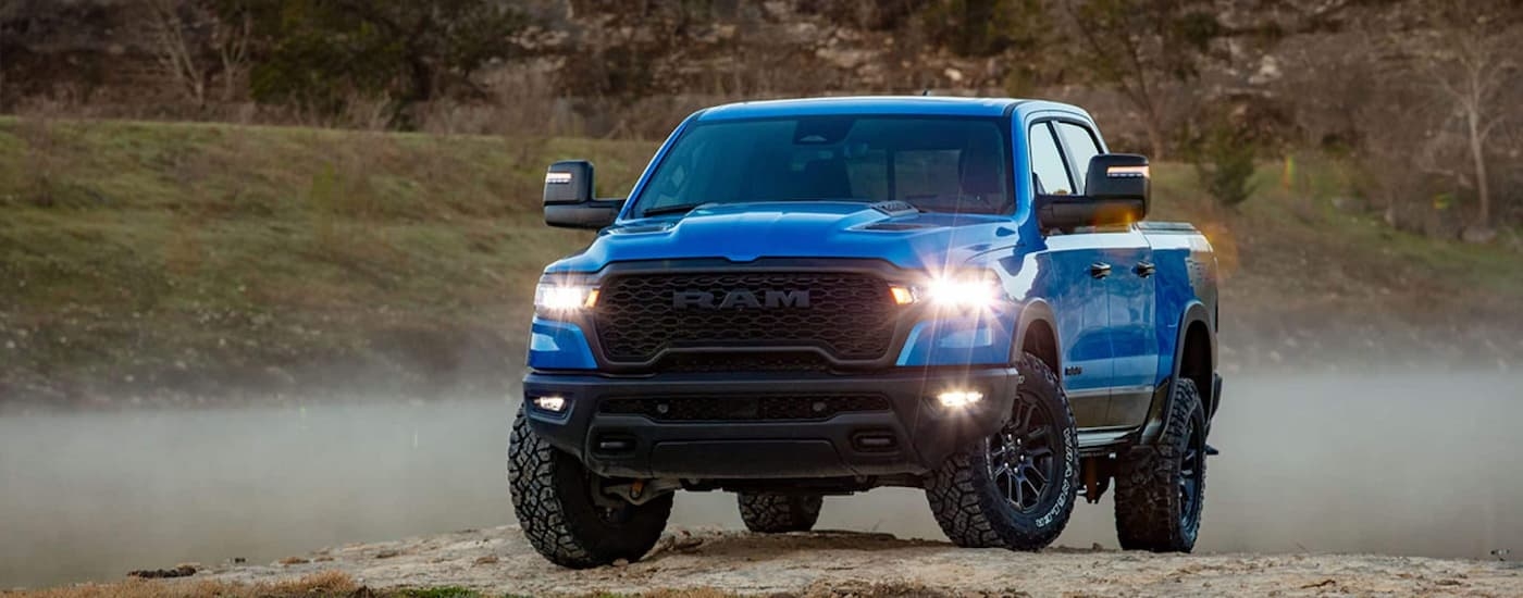 Blue 2025 Ram 1500 for sale near Kingston parked off-road.