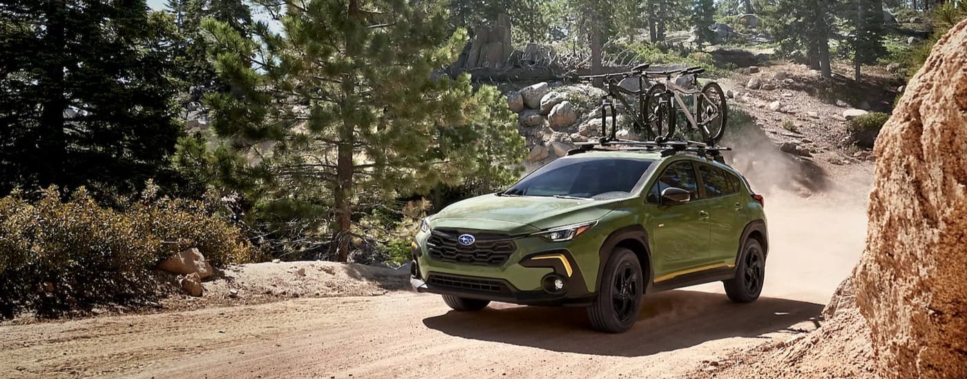 A green 2026 Subaru Crosstrek driving off-road.
