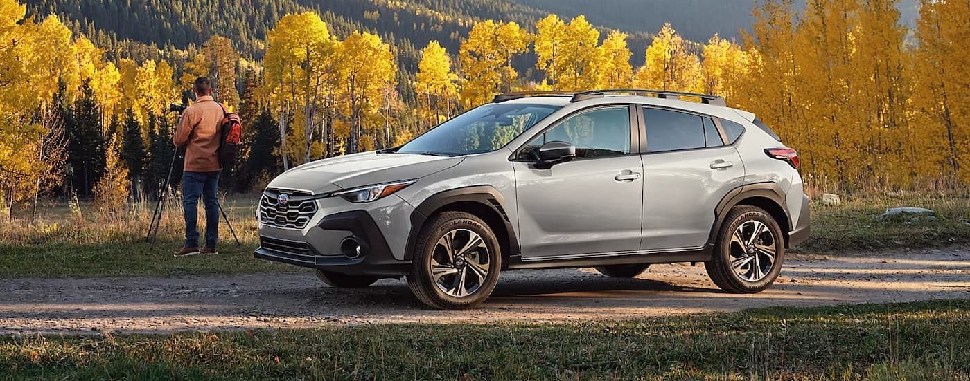 A silver 2026 Subaru Crosstrek parked near a photographer.