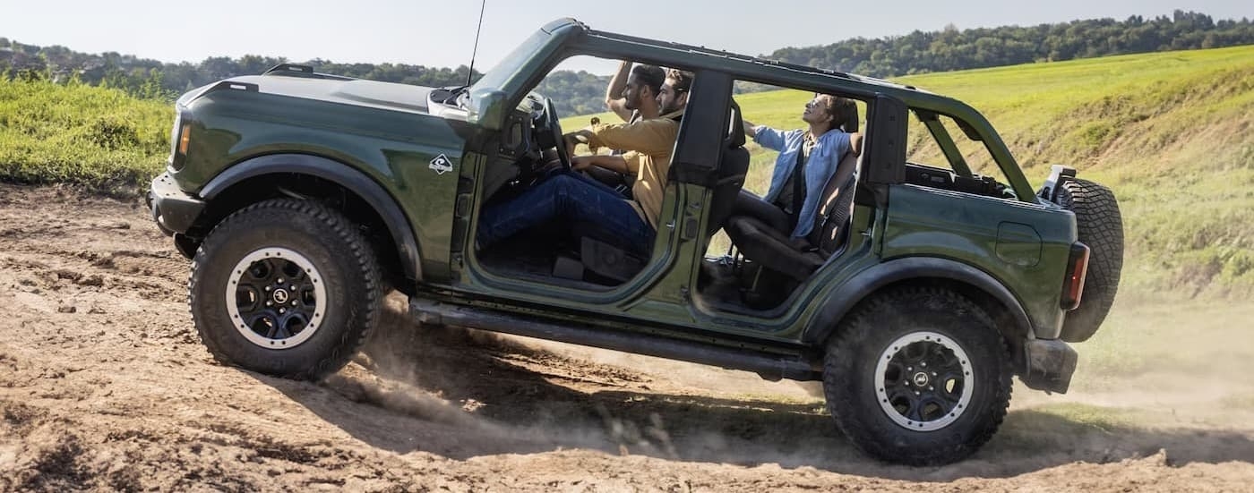 A green 2025 Ford Bronco off-roading.