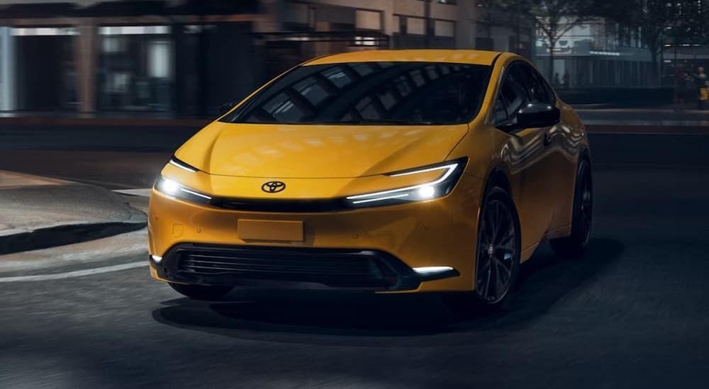 A yellow 2026 Toyota Prius driving in a city.