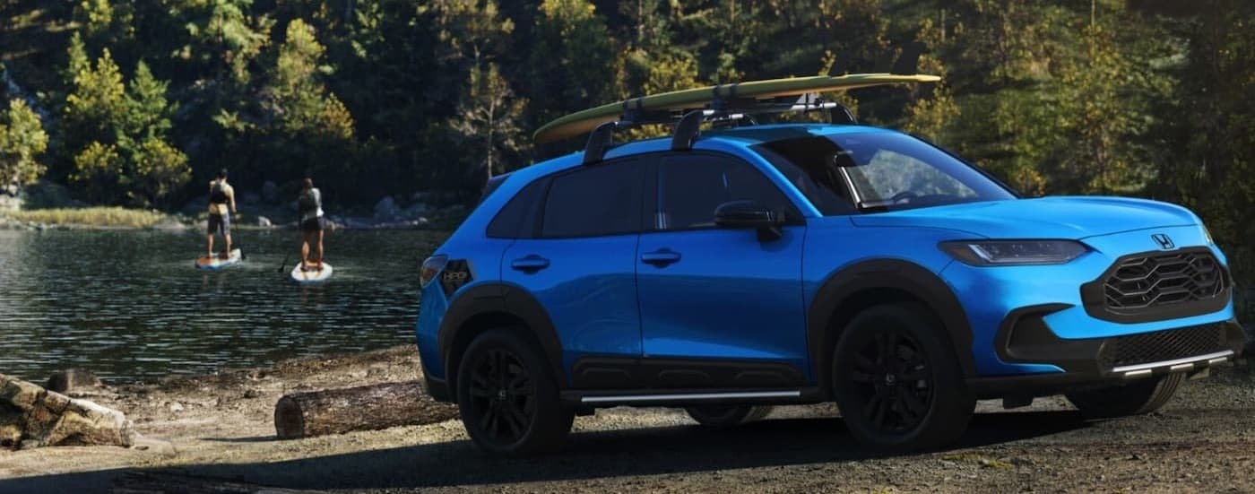 A blue 2026 Honda HR-V parked near a lake.