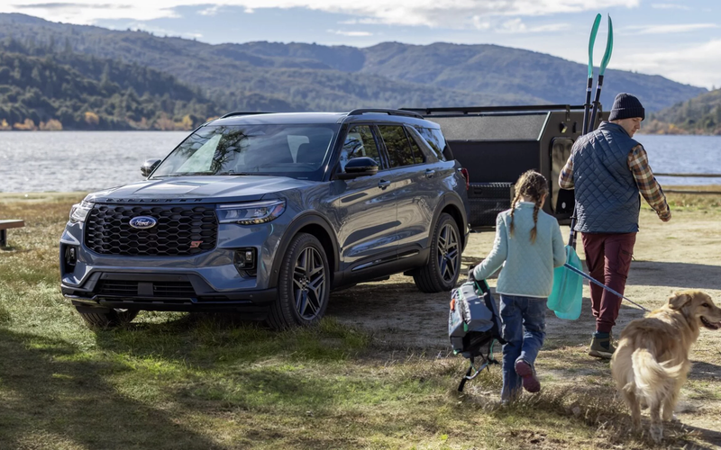 A reliable Ford Explorer SUV parked with a family SUV in the background, symbolizing family transport.