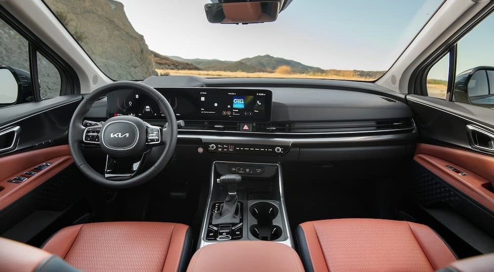 The black and brown interior and dash in a 2026 Kia Carnival.