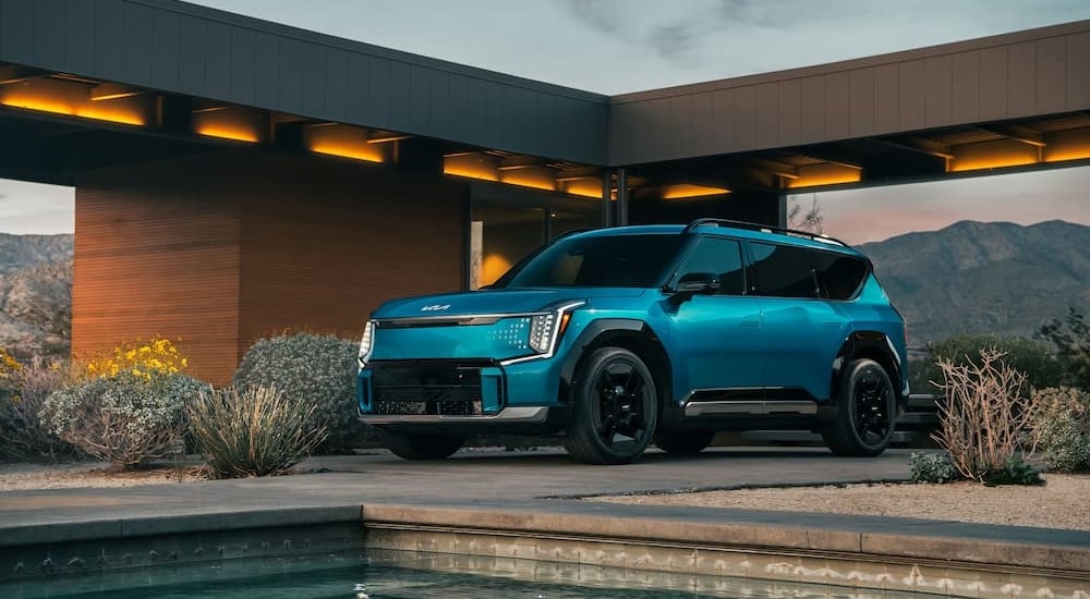 A blue 2026 Kia EV9 GT-Line parked after visiting a Kia dealer near Katy.