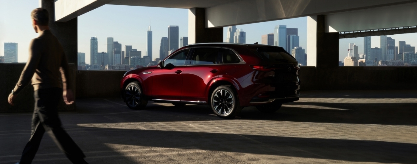 A red 2025 Mazda CX-90 from the side.