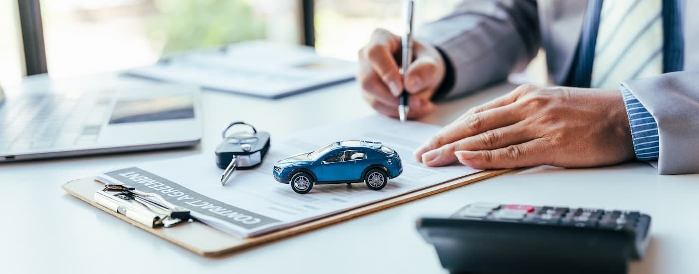 A person signing documents.