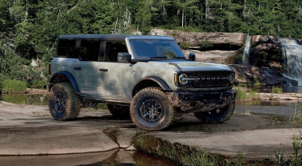 A grey 2025 Ford Bronco from the side while parked off-road.