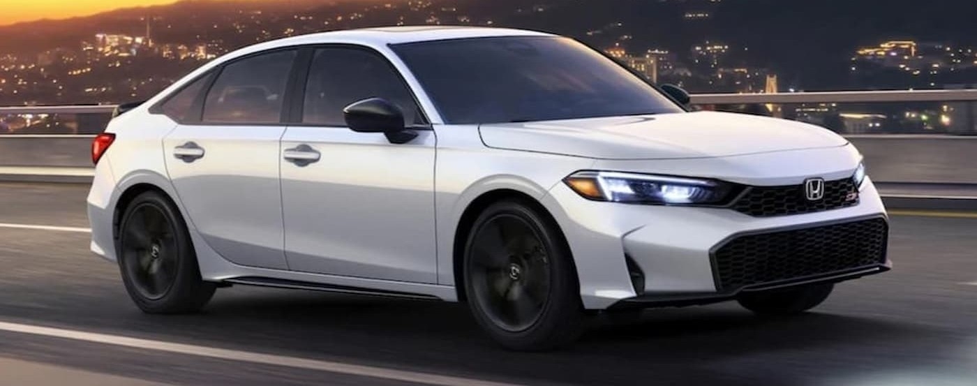 A white 2026 Honda Civic driving after viewing a used Honda near Coral Gables.