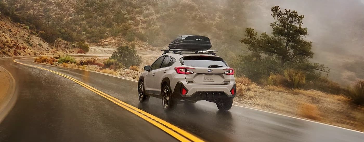 A tan 2026 Subaru Crosstrek driving on a highway.