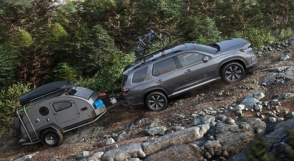 A grey 2025 Honda Pilot from the side.