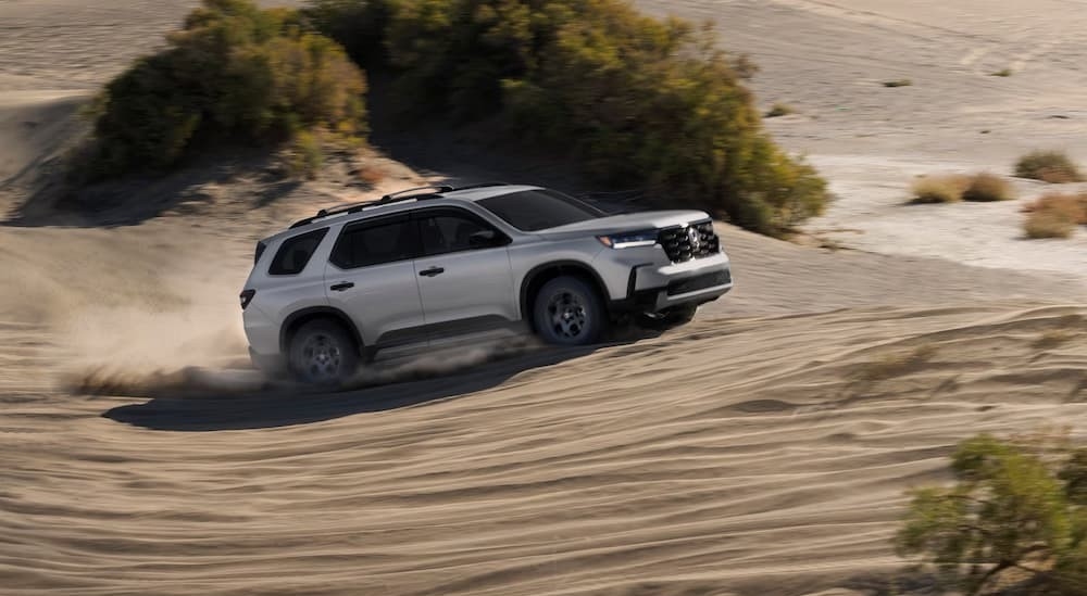 A silver 2025 Honda Pilot off-roading.