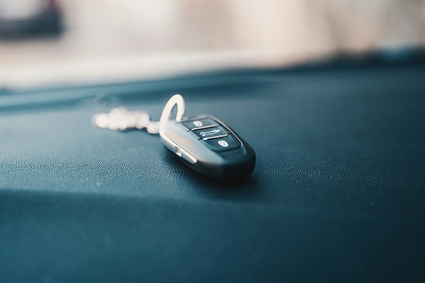 car key fob sitting on a dashboard of a car 