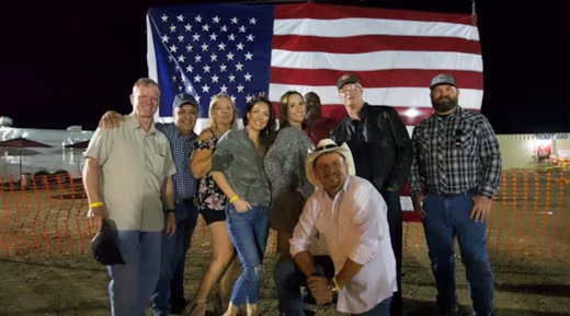 Roy Stockton with community members and American flag
