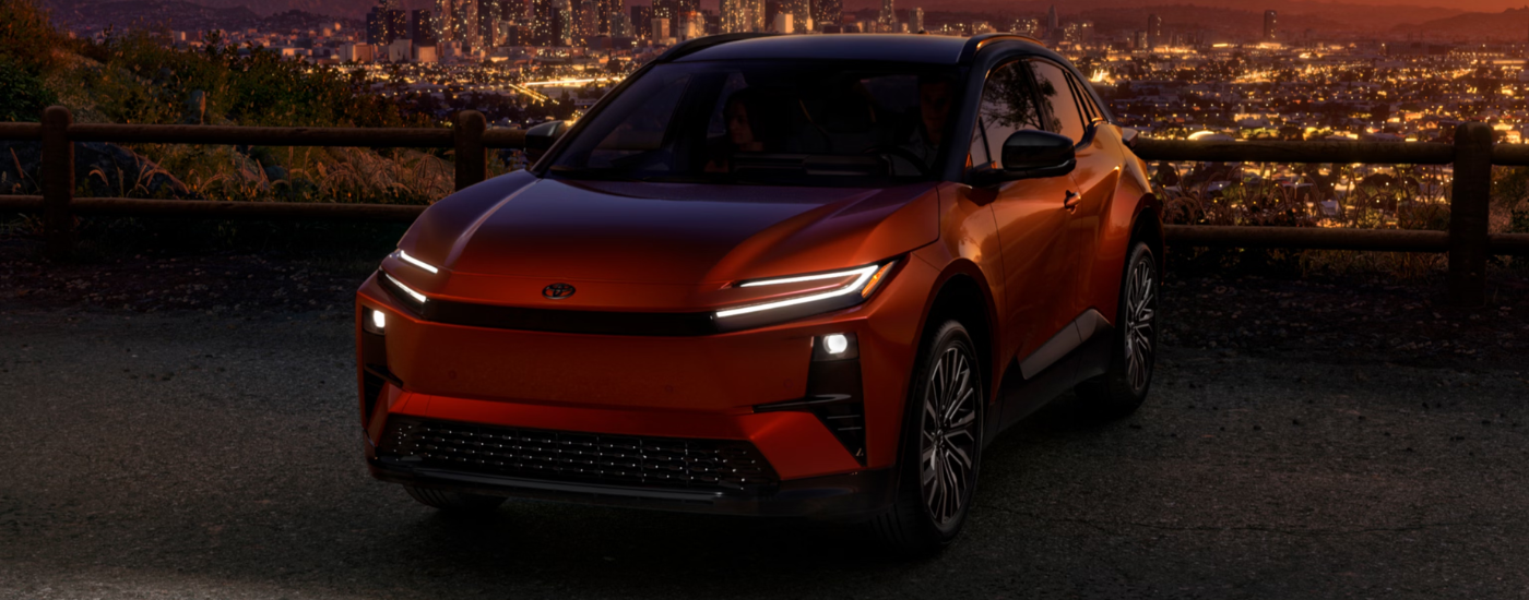 Orange 2026 Toyota CH-R parked overlooking a city