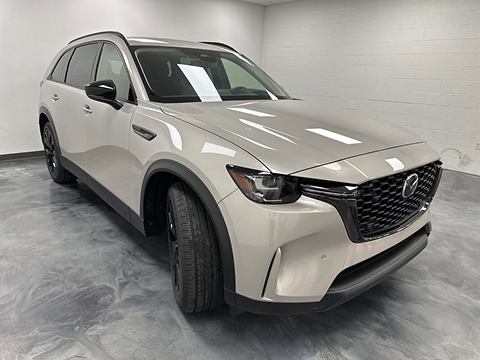tan 2026 Mazda CX-90 SUV parked at the Bountiful Mazda dealership in Bountiful, UT