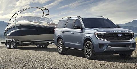blue 2026 Ford Expedition SUV towing a boat