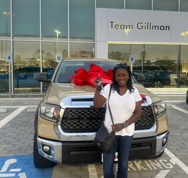 Smiling Woman with New Volkswagen at Team Gillman Volkswagen of Kingwood