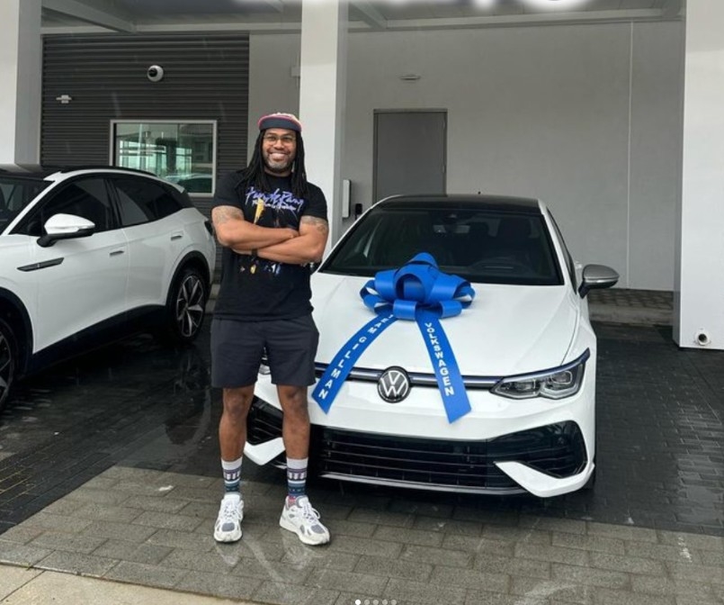 Smiling Man with New Volkswagen at Team Gillman Volkswagen of Kingwood