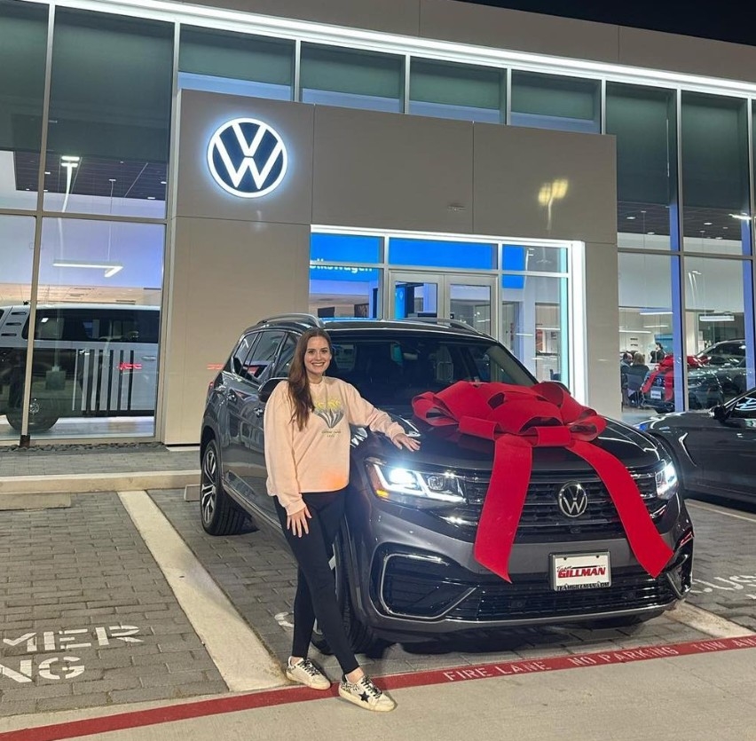Smiling Woman and her new VW car near Porter, TX | Volkswagen Dealer