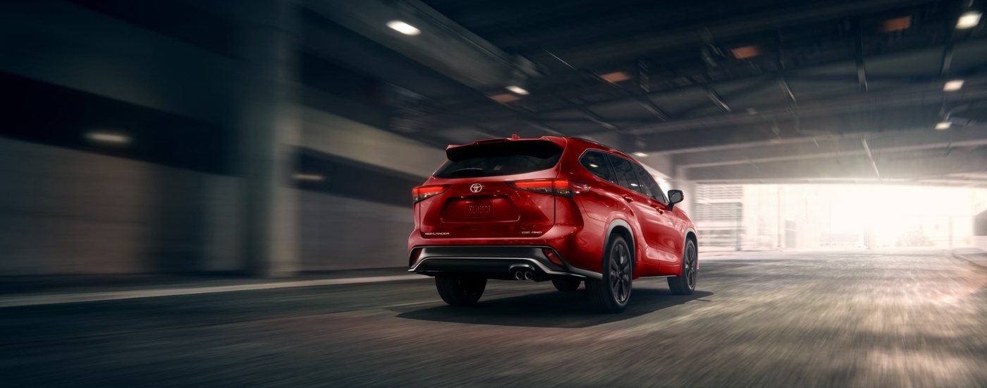 Red 2026 Toyota Highlander XSE driving through a tunnel