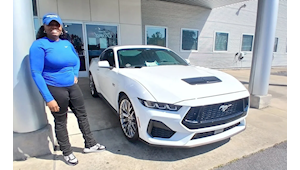 Customer standing next to their new Ford Mustang at Homer Skelton Ford