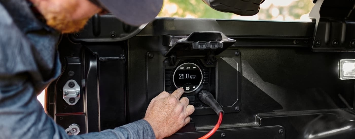 Person checking the PSI meter on 2024 Toyota Tacoma for sale near Yonkers
