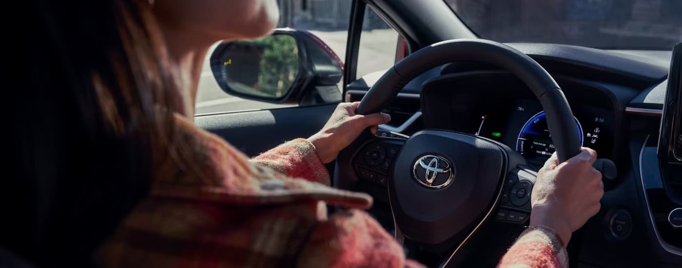 Woman test driving a 2026 Toyota Corolla for sale