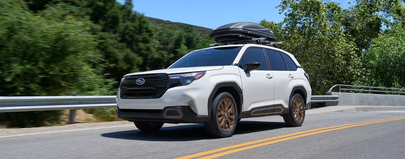 White 2026 Subaru Forester Sport driving on a highway