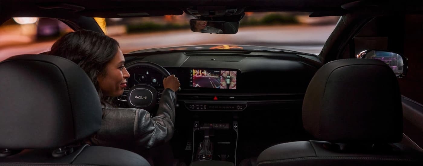 Woman driving in a 2025 Kia Sorento at night