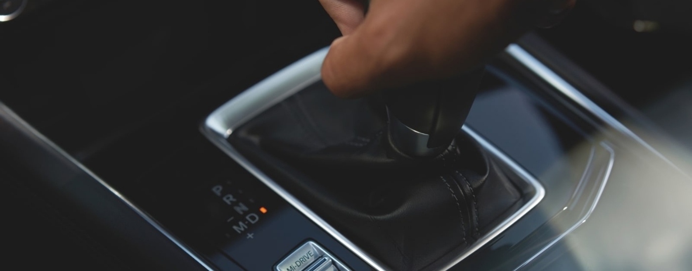 Person using the gear selector in a 2025 Mazda CX-5 for sale near Doral