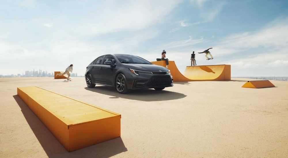 Grey 2026 Toyota Corolla Hybrid SE at a skate park