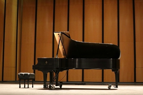 a black grand piano on a stage