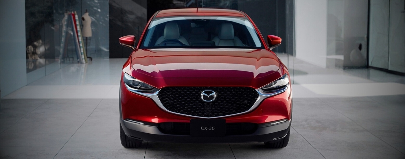 Red 2025 Mazda CX-30 for sale near North Miami parked in a modern building