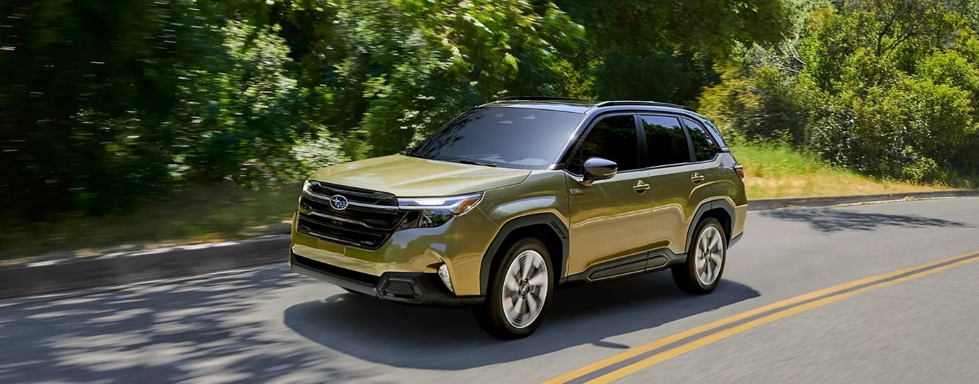 A green 2025 Subaru Forester from the front at an angle.