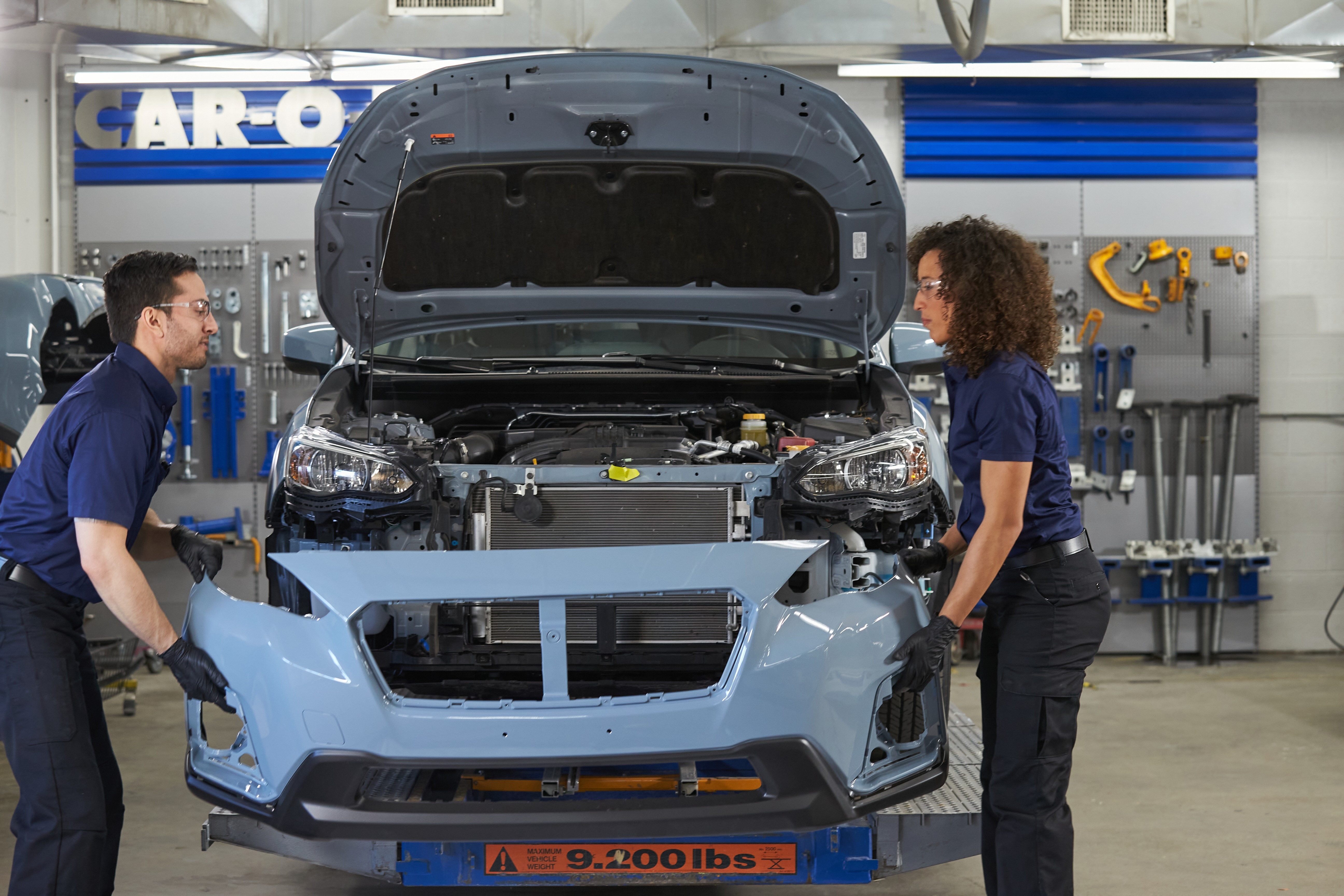 Technicians working on a rebuilt vehicle at Mark Miller Subaru