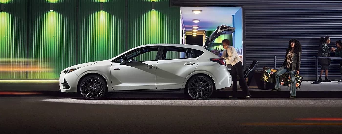 Side of a white 2026 Subaru Impreza being loaded with instruments