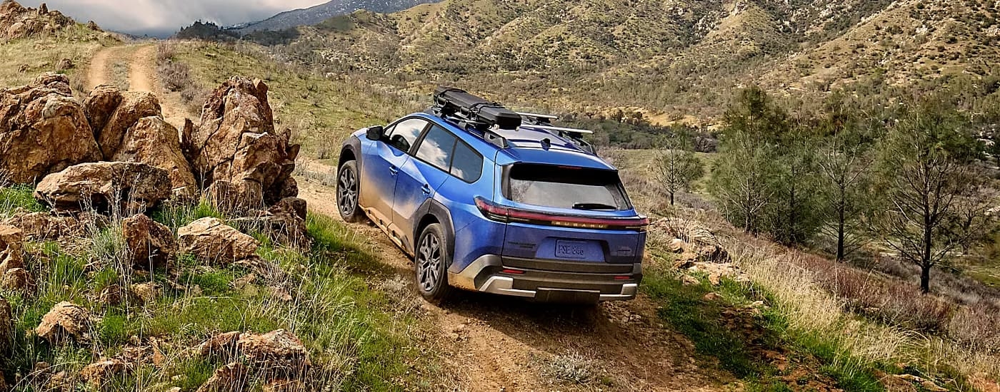 Blue 2026 Subaru Trailseeker off-roading on a mountain trail