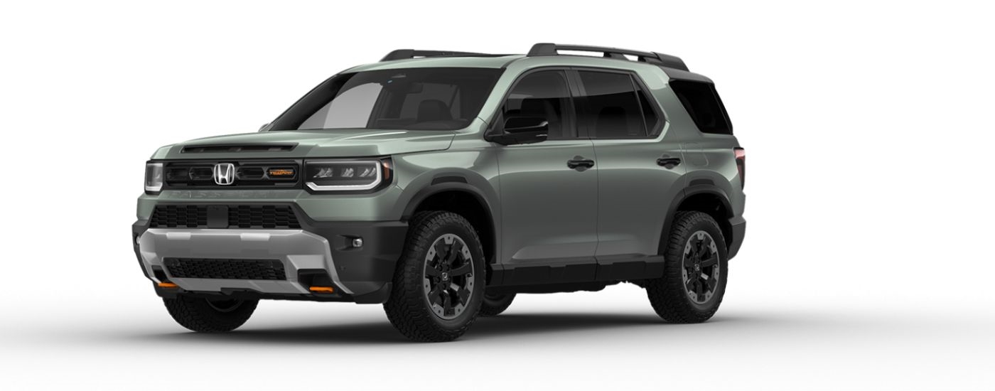 A green 2026 Honda Pilot TrailSport Elite angled left.