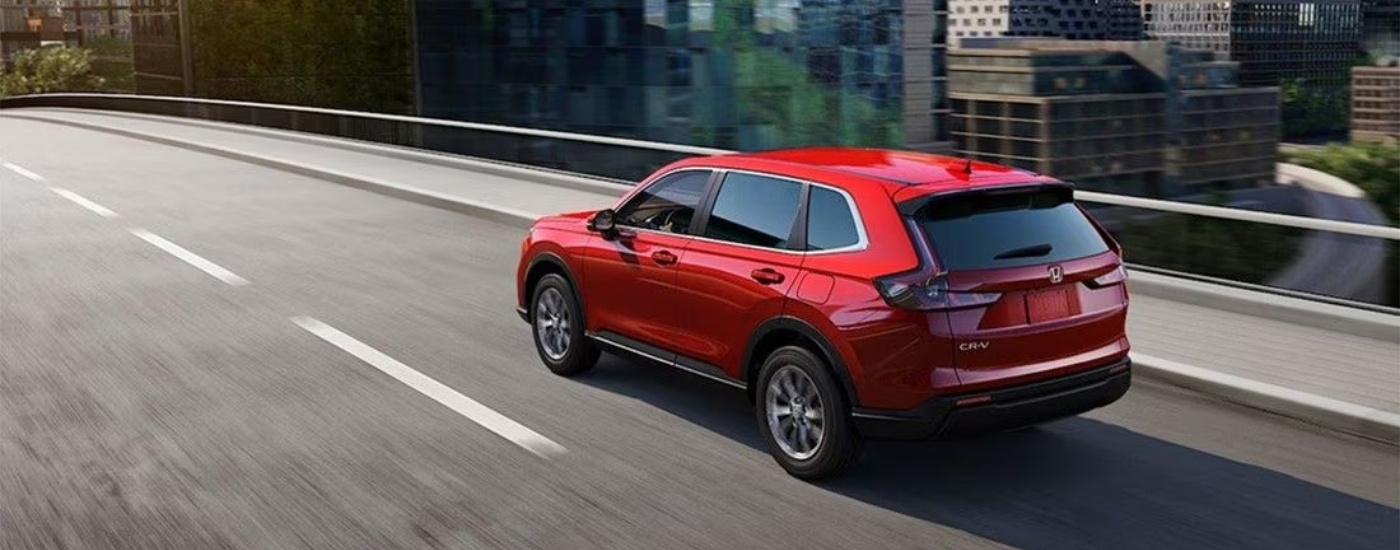 A red 2025 Honda CR-V from the side.