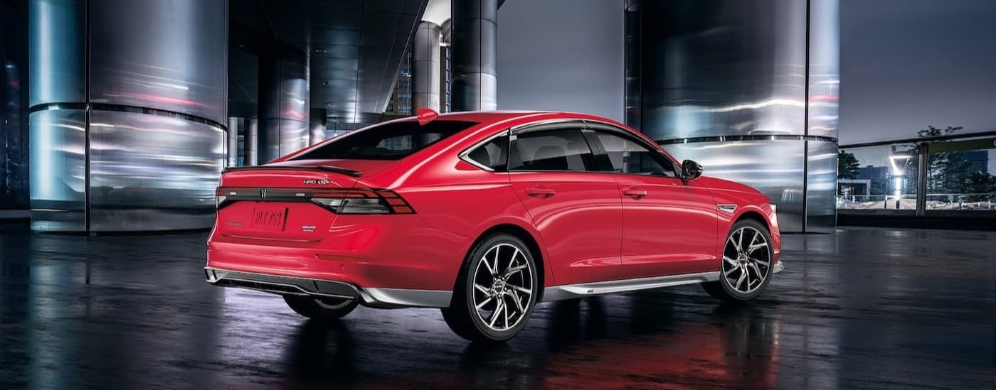 A red 2025 Honda Accord parked in a city.