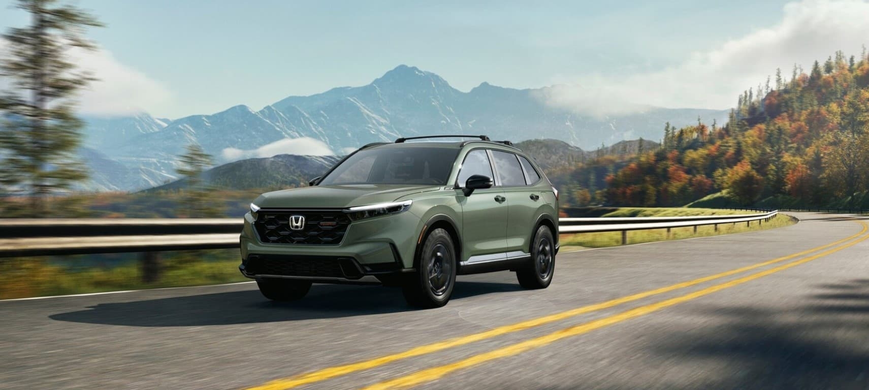 A green 2026 Honda CR-V driving on a highway.