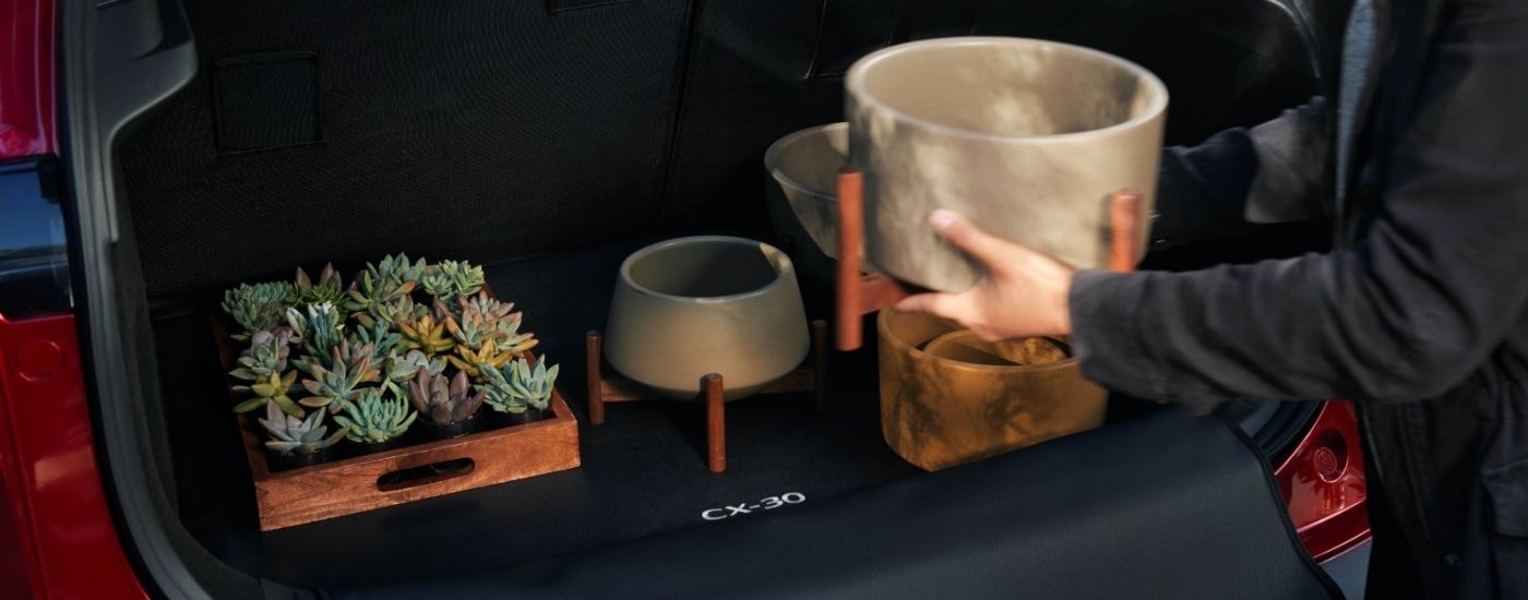 Person loading containers into a 2026 Mazda CX-30