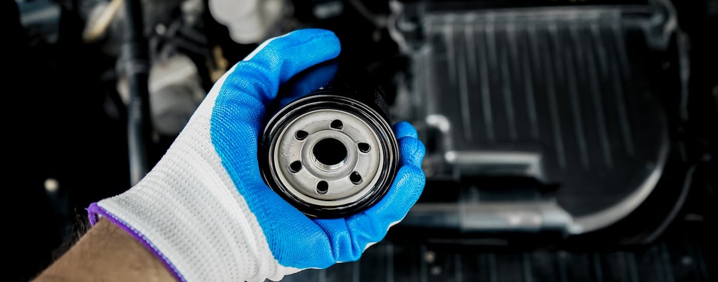 Mechanic holding an oil filter at a Toyota service center