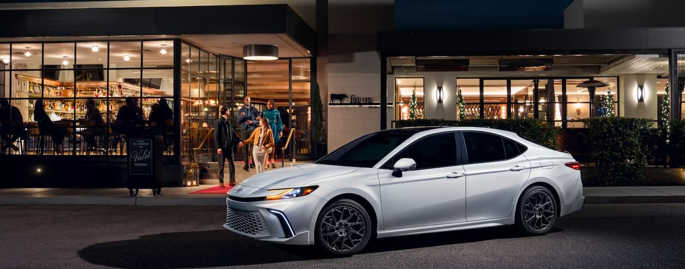 White 2025 Toyota Camry XSE parked outside of a restaurant