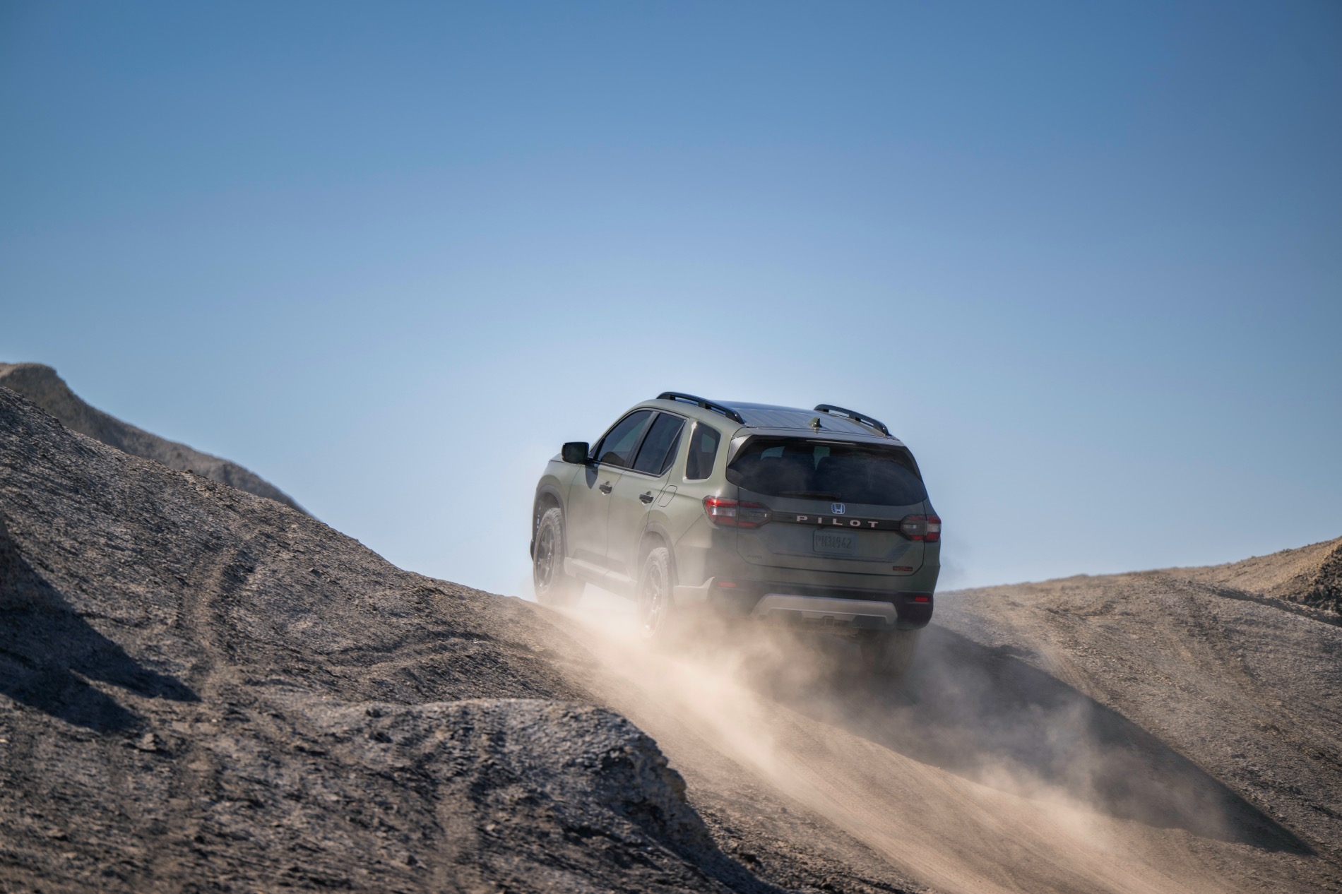 2026 Honda Pilot TrailSport climbing a large rock formation