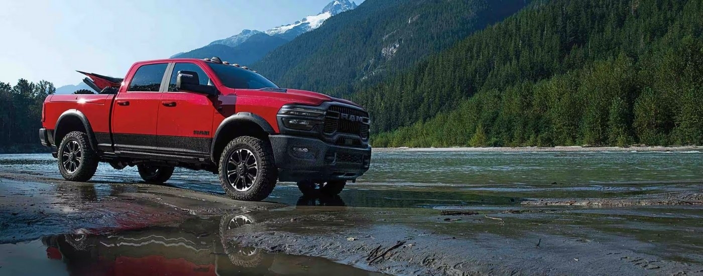Red 2025 Ram 2500 parked near a river