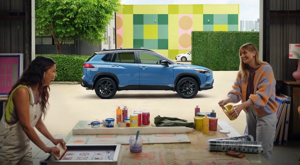 A blue 2026 2026 Toyota Corolla Cross parked in a city.