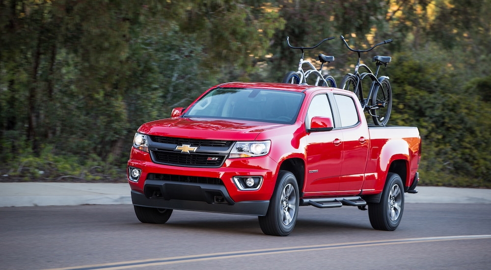 Red 2018 Chevy Colorado Z71 driving down a road.